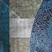 Sicis Vetrite mosaic tiles in grey, blue, and silver showcase a diagonal, curved pattern with textured grey stone panels flanking the design.